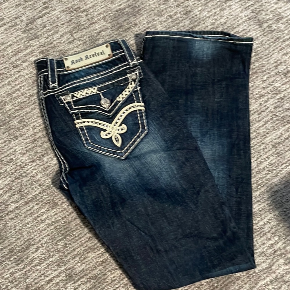 Women’s boot cut Rock Revival jeans with white logo and diamond pockets